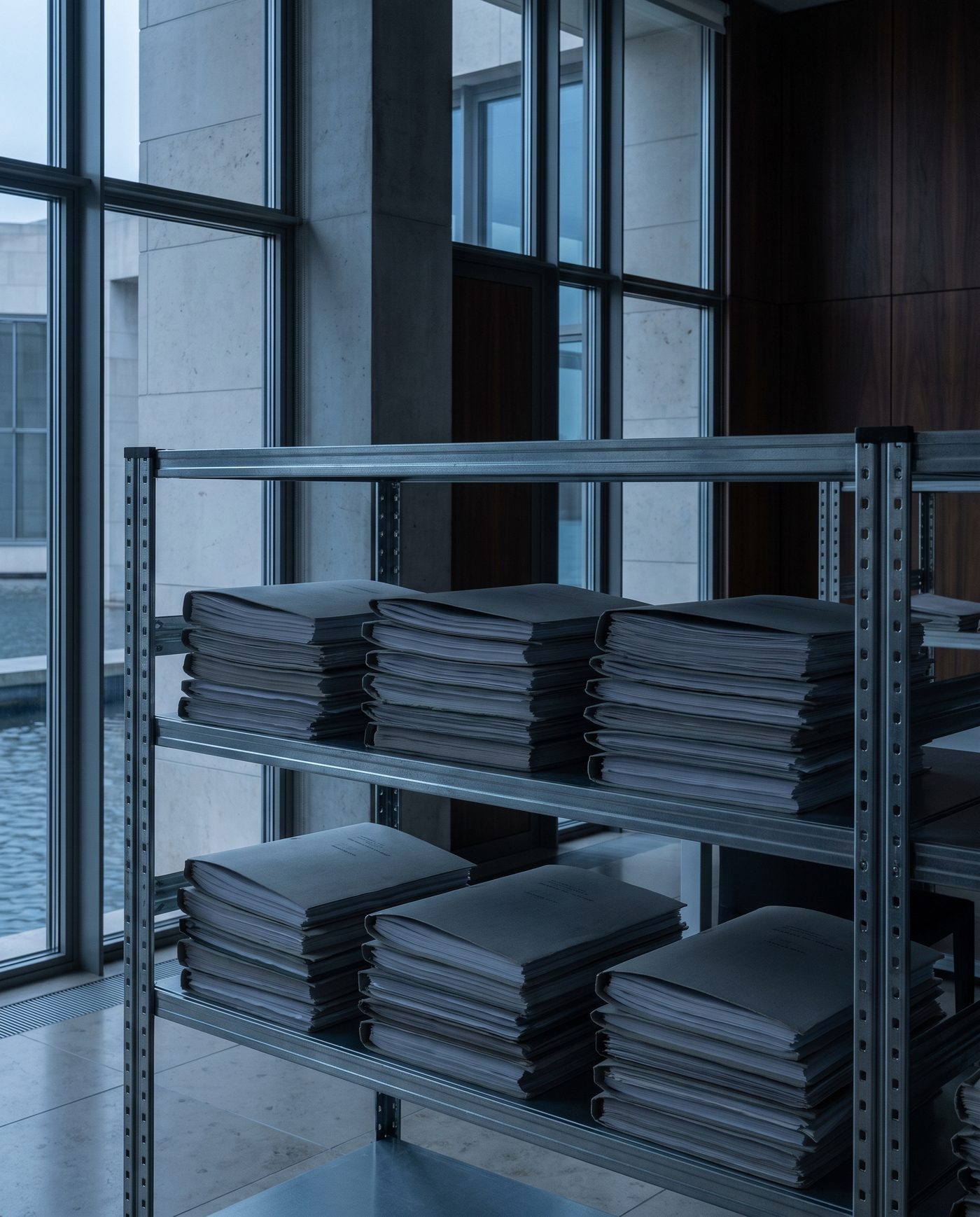 A stack of policy folders, each a slightly different grey.